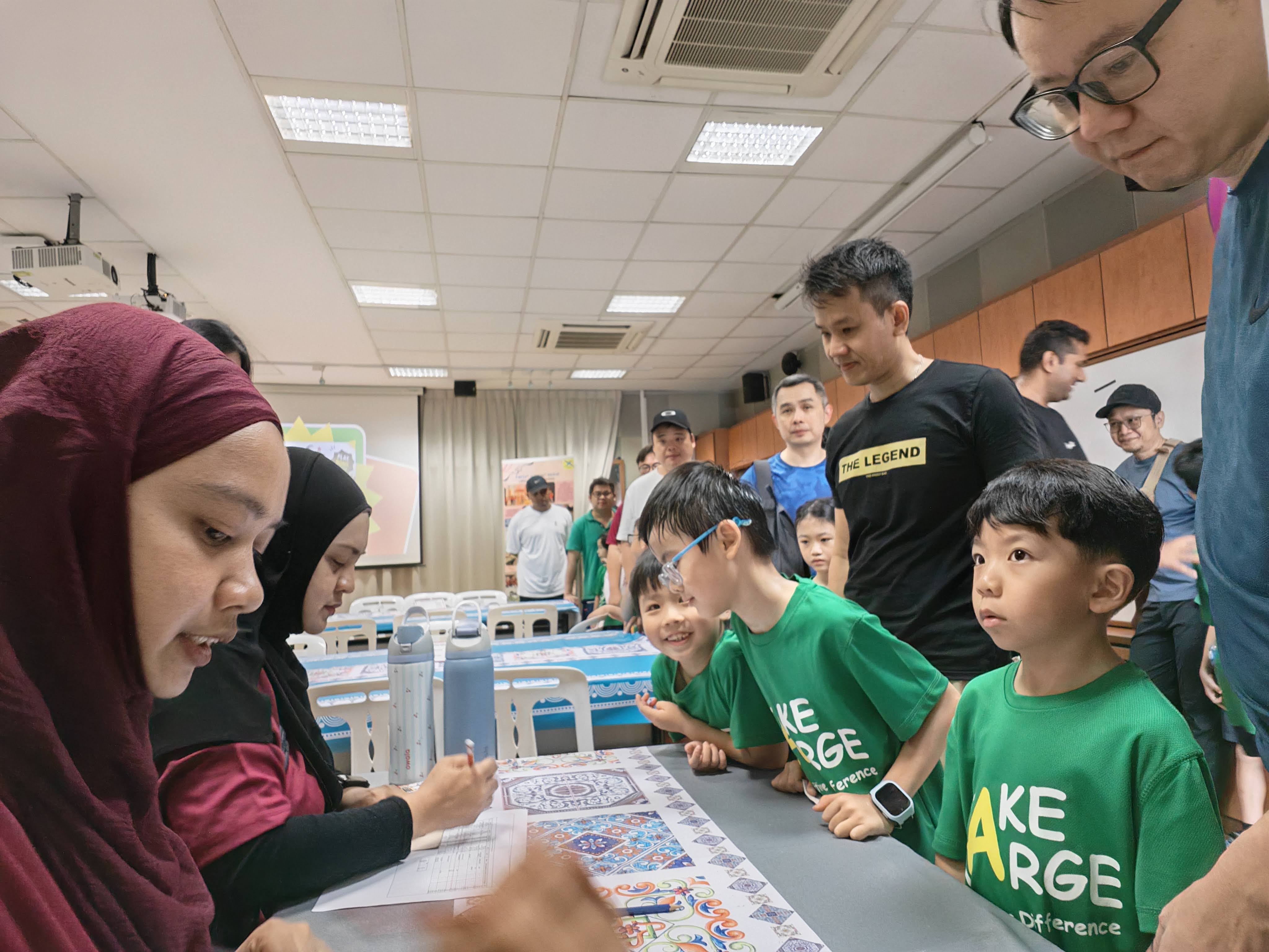 Fathers and their children checking in at the counter to collect their game cards to get the games started